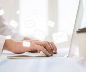 Chart storage employee's hands typing on open laptop to patients requesting files