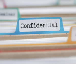 Close up view of medical files with tabs showing saying "Confidential"